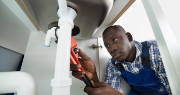 Handyman Repairing Sink Pipe
